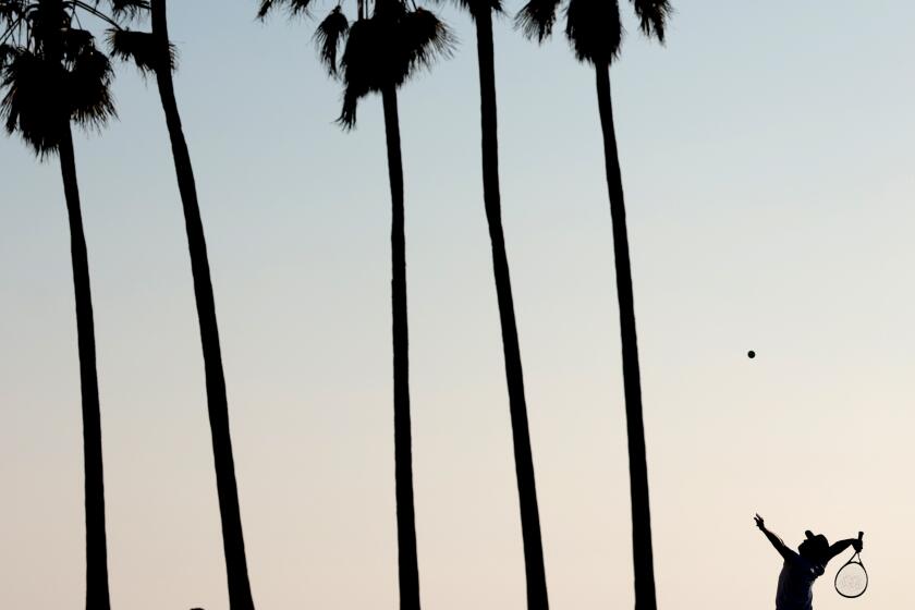 VENICE, CALIFORNIA- A man plays tennis against a wall in Venice Beach during a warm afternoon Tuesday. (Wally Skalij/Los Angeles Times)