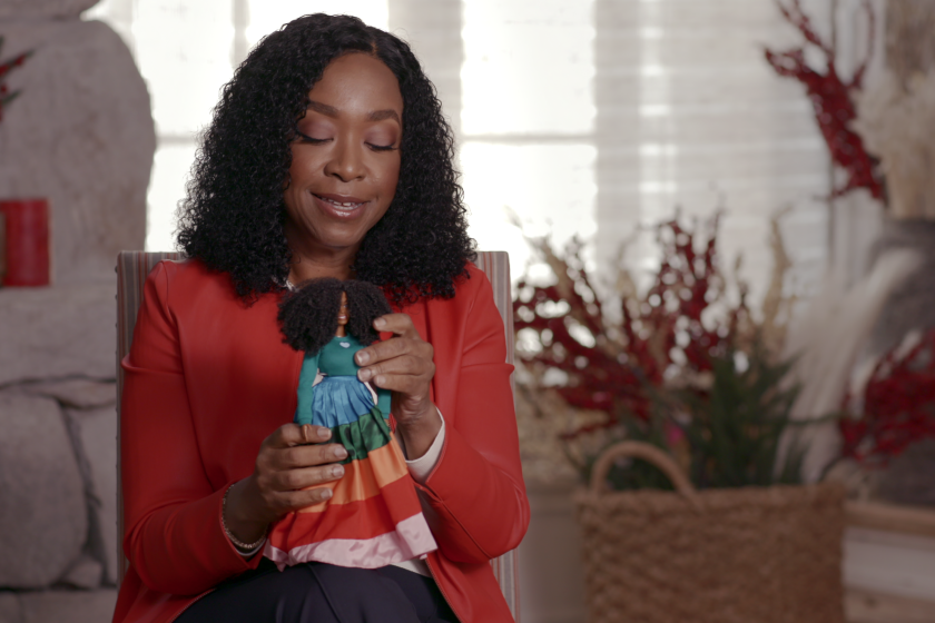 Shonda Rhimes with the Barbie based on her image in a scene from the new Netflix documentary "Black Barbie"