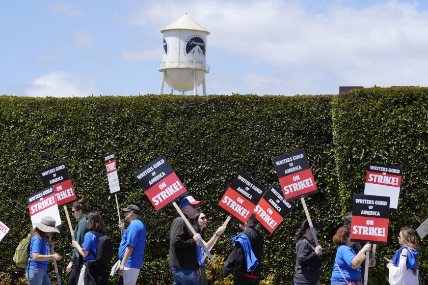 Striking writers take part in a rally in front of Paramount Pictures studio, Tuesday, May 2, 2023, in Los Angeles. Television and movie writers launched a strike for the first time in 15 years, as Hollywood girded for a walkout with potentially widespread ramifications in a fight over fair pay in the streaming era. (AP Photo/Chris Pizzello)