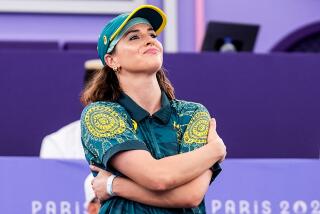 Australian B-Girl Raygun wraps her arms around her torso before competing at the Paris Olympics