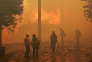 RUNNING SPRINGS, CA - SEPTEMBER 10, 2024: Firefighters can do little to save an engulfed home as the Line fire burns into a tree lined neighborhood on September 10, 2024 in Running Springs, California. (Gina Ferazzi / Los Angeles Times)