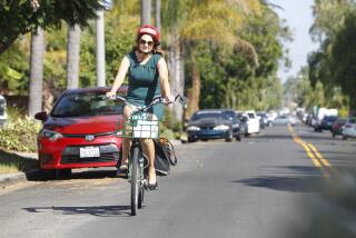 Nicole Capretz, founder and executive director of Climate Action Campaign, rides her electric bike to work on October 10, 2019 in San Diego, California.