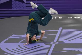 Australia's Rachael Gunn, known as B-Girl Raygun, stands on her head during the breaking competition 2024 Paris Olympics