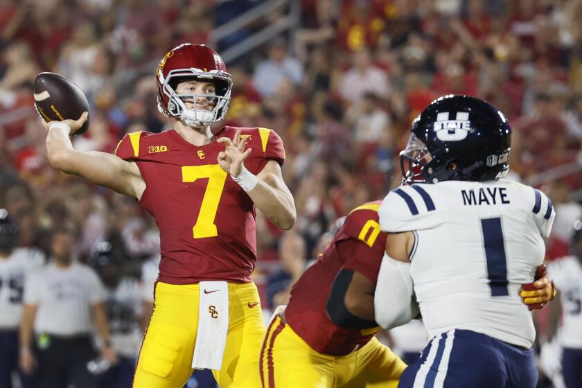 Los Angeles, CA - September 07: USC starting quarterback Miller Moss, #7, left, passes the ball during the first quarter against Utah State in the USC home opener at LA Memorial Coliseum in Los Angeles Saturday, Sept. 7, 2024. (Allen J. Schaben / Los Angeles Times)