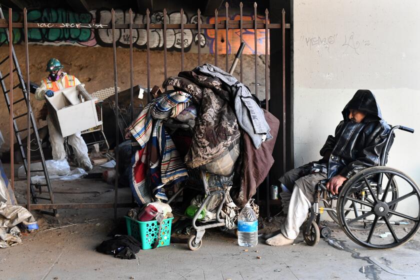 Inglewood, California January 25, 2022: A homeless that goes by the name "Richard" is kicked out of a homeless encampment under the 405 freeway in Inglewood Tuesday morning as work crews clean-up personal belongings and trash in preparation for the Super Bowl. (Wally Skalij/Los Angeles Times)