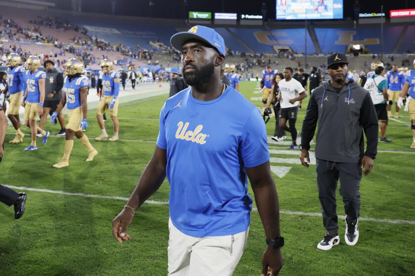 Pasadena, CA - September 14: UCLA head coach DeShaun Foster walks off the field.