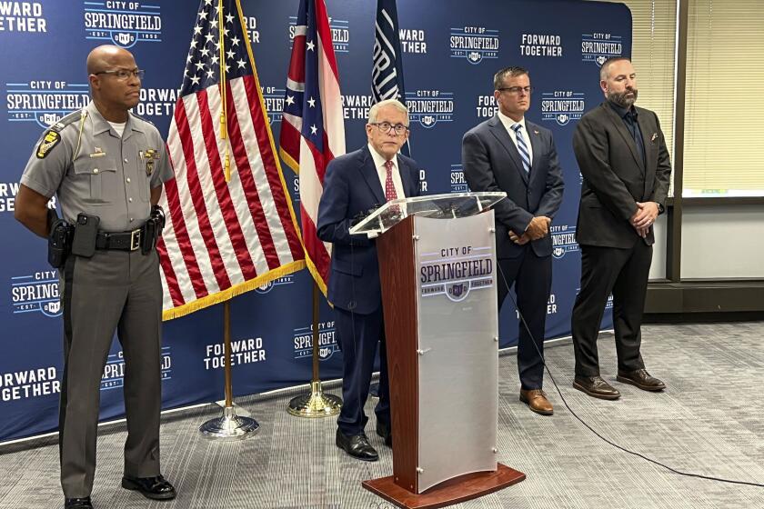 Ohio Gov. Mike DeWine (R) speaks at a press conference at Springfield City Hall alongside Ohio State Highway Patrol Colonel Charles Jones, left, Director of the Department of Public Safety Andy Wilson, second from right, and Springfield City School Superintendent Robert Hill, right, in Springfield, Ohio, Monday, Sept. 16, 2024. (AP Photo/Patrick Aftoora-Orsagos)