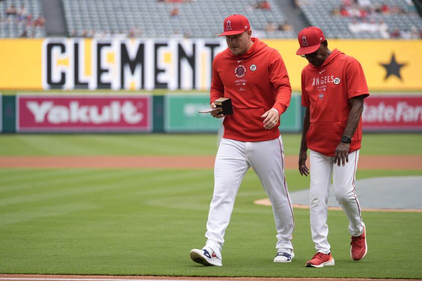 Los Angeles Angels' Mike Trout, left, is recognized as the Angels' 2024 Roberto Clemente Award.