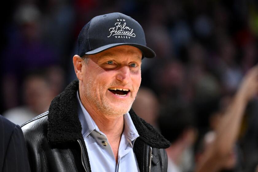 Woody Harrelson, in a Sun Valley Film Festival hat and leather jacket, attends the 2023 NBA playoffs at Crypto.com Arena