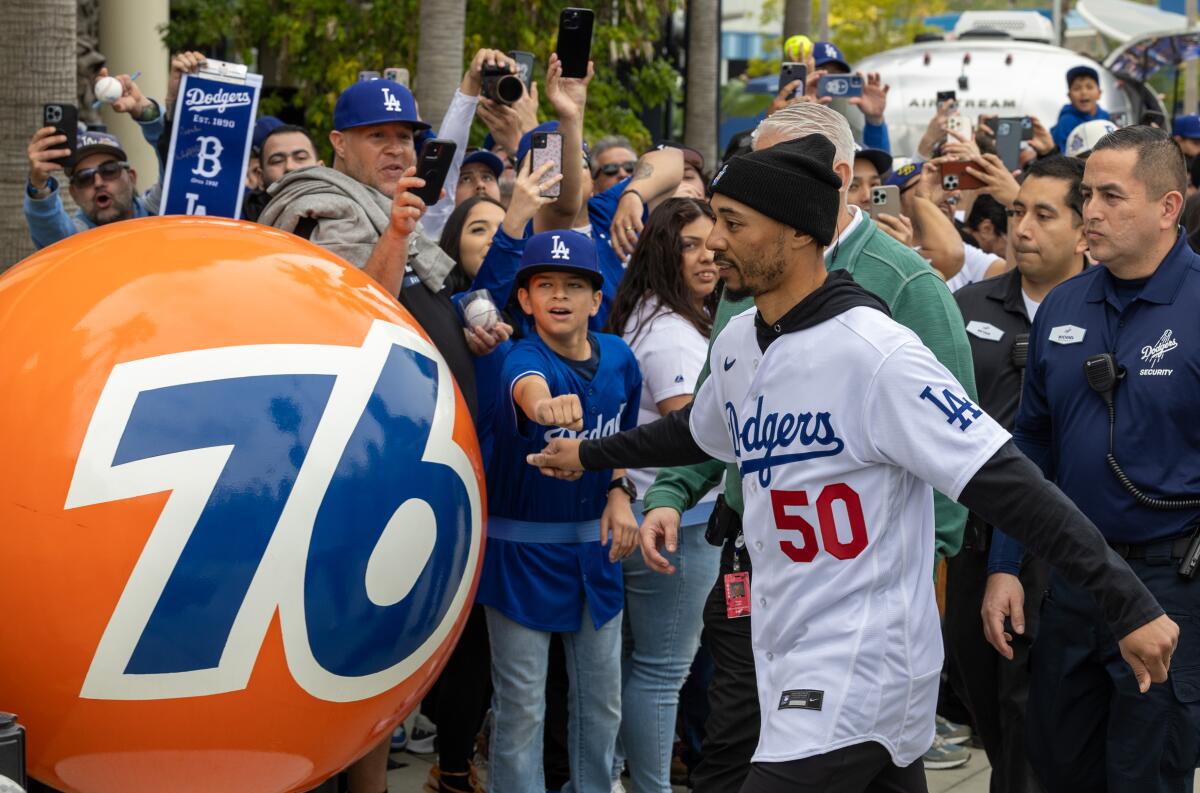 Dodgers star Mookie Betts fist-bumps fan Andrew Ruiz, 12, at DodgerFest in February.