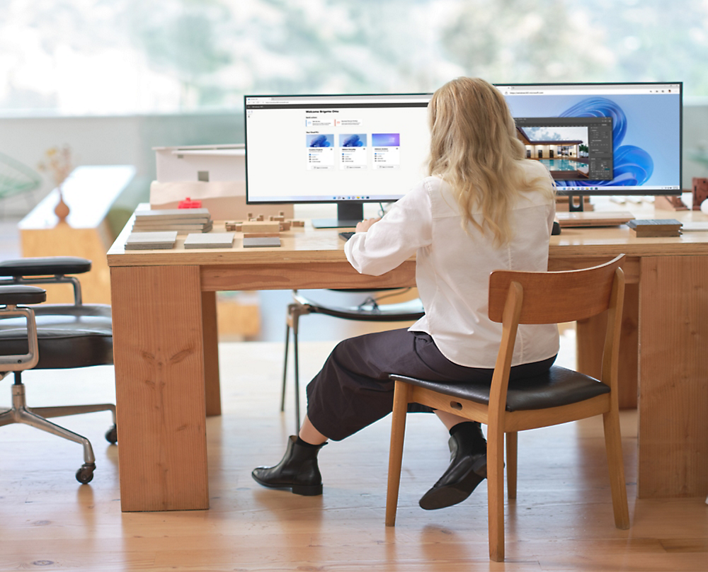 A person sitting at a desk looking at a computer