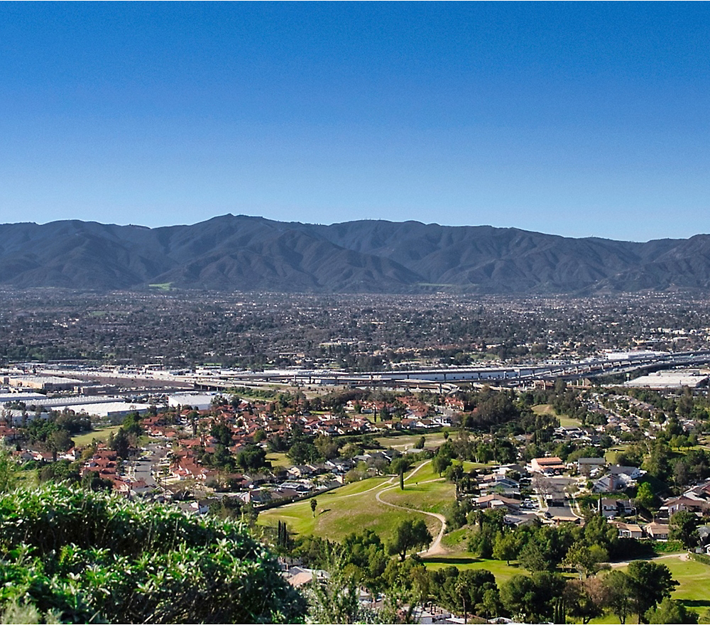 A city with a river and mountains in the background