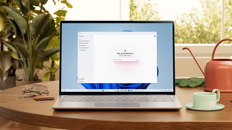 A Windows laptop showing the Copilot app sitting on top of a table