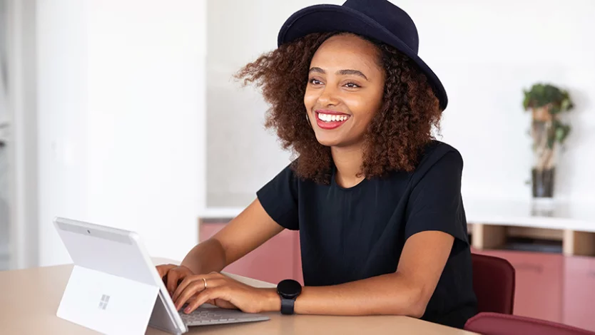 Personne assise à un bureau et travaillant sur un ordinateur portable