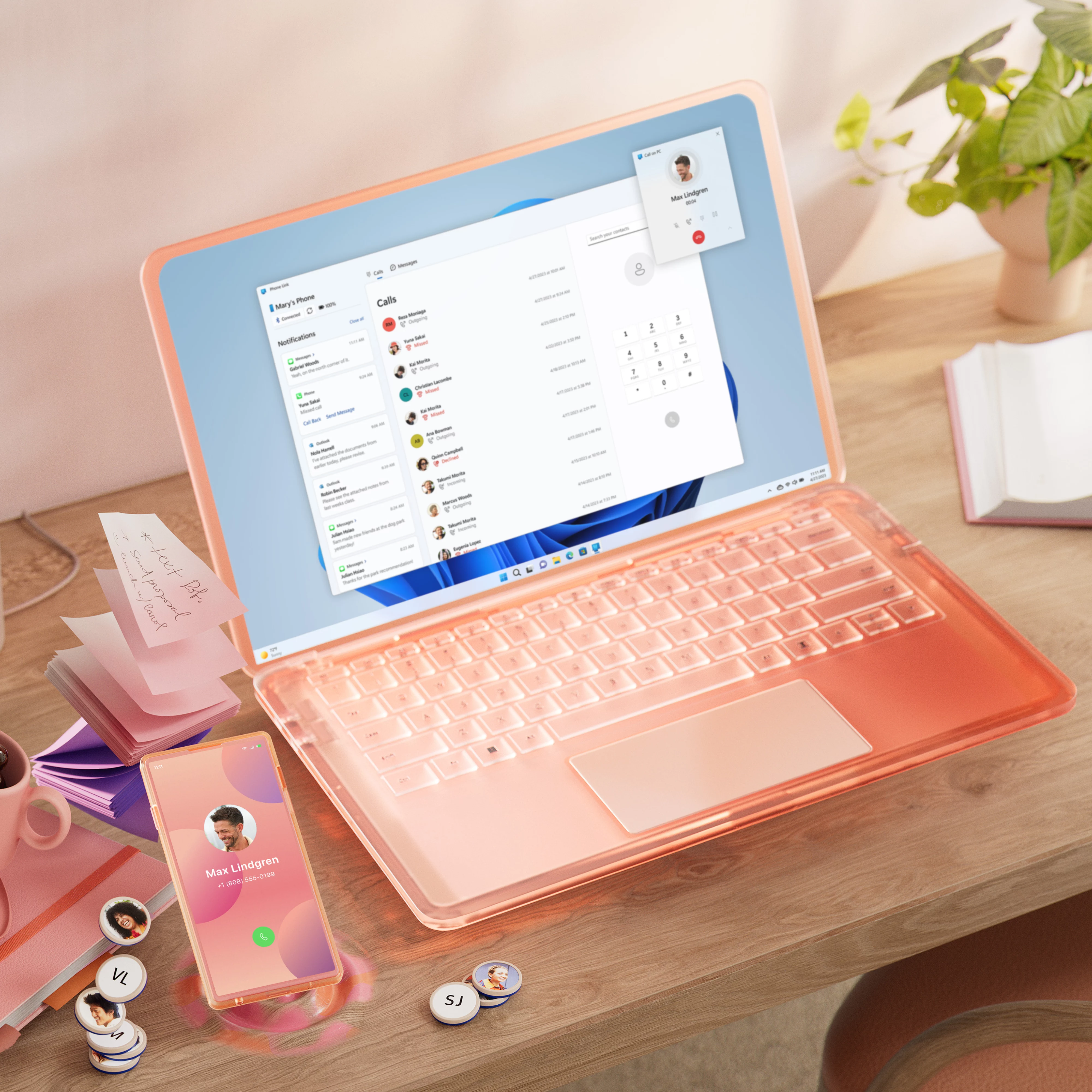 Colourful PC and mobile device sitting on a desk with a cup of coffee and pen