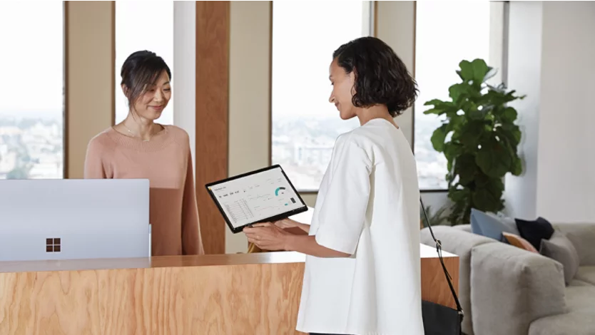 Two women looking at a Surface screen