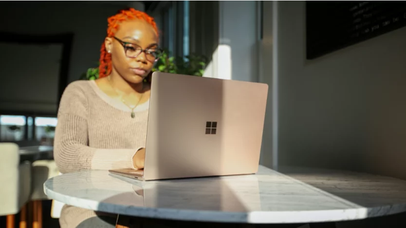 Woman typing on a Surface Laptop