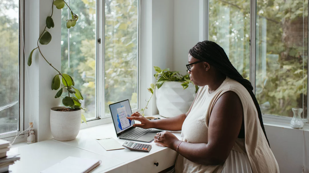 Woman using a Windows 11 laptop at a desk