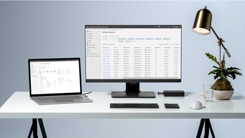 a Microsoft Surface Laptop on a modern desk with a monitor, keyboard, and wireless mouse