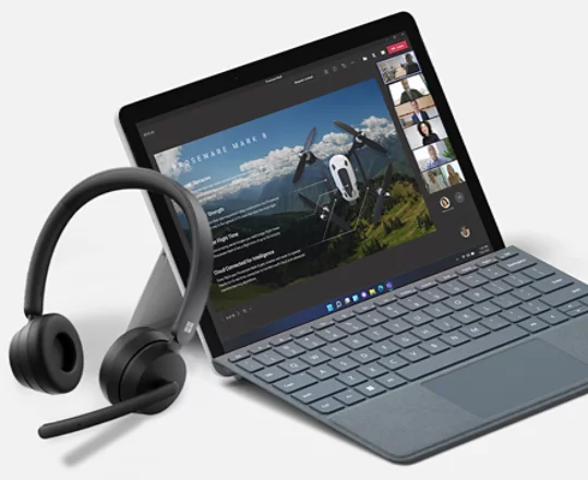 A render of Microsoft Modern Wireless Headset leaning against a Surface device