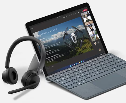 A render of a Microsoft Modern Wireless Headset leaning against a Surface device