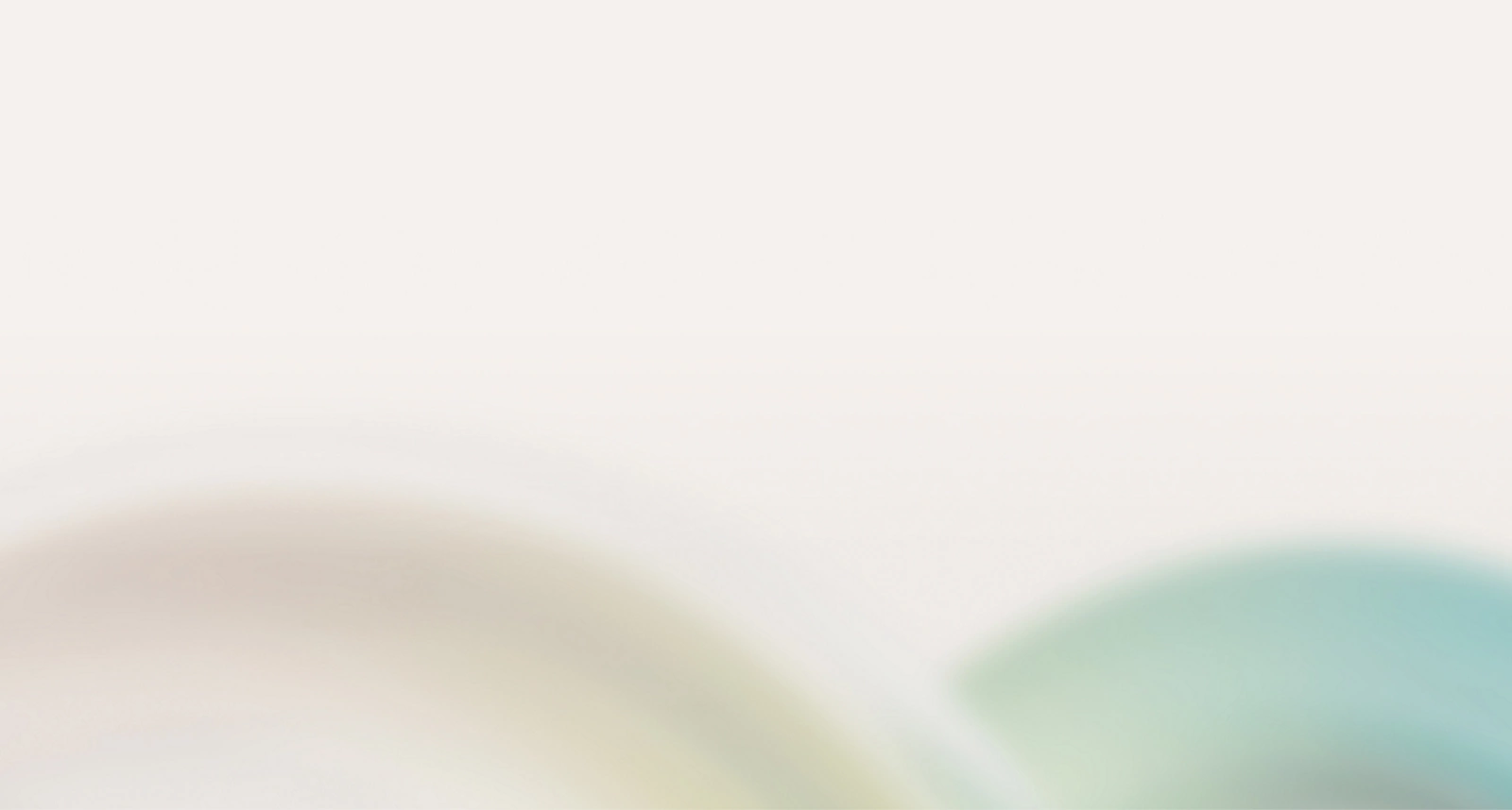 Fondo borroso abstracto con colores pastel suaves, principalmente blanco con sutiles indicaciones de verde y azul.