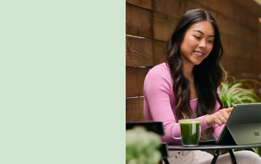 A woman works outside on her Sage Surface Pro 9