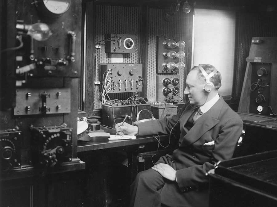 Italian physicist Guglielmo Marconi at work in the wireless room of his yacht Electra, c. 1920.