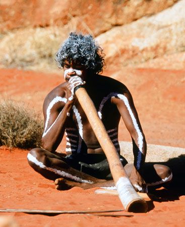 playing a didjeridu