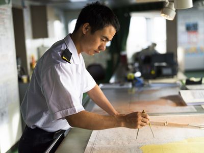 officer using charts for navigation