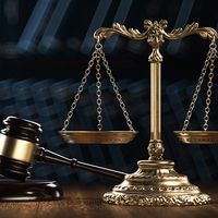 Law legal system crime concept with gavel and scales of justice with books in the background. (mallet, judicial system).