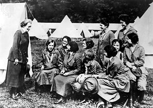 Juliette Gordon Low (left), founder of the Girl Scouts of America, speaking to Girl Guide leaders in England, 1920.