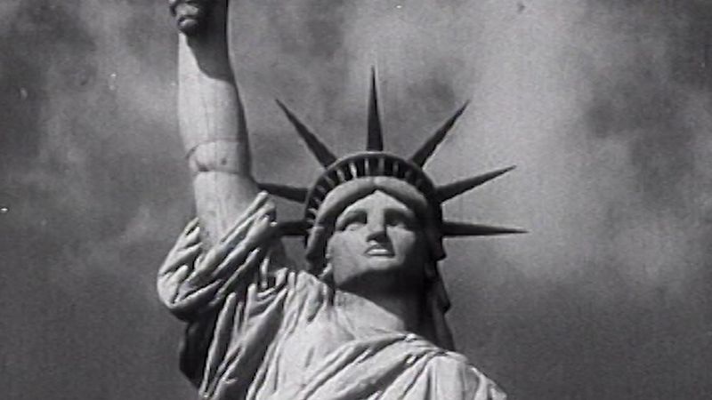 Behold the Statue of Liberty as a symbol of the American dream to hopeful immigrants arriving at Ellis Island