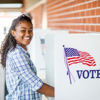 A young black girl voting on election day