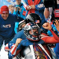 Former U.S. Army World Class Athlete Program bobsledder Steven Holcomb, front, is greeted at the finish line after teaming with Justin Olsen, Steve Mesler and Curtis Tomasevicz to win the first Olympic bobsleigh gold medal in 62 years for Team USA ,(cont)