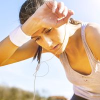 Young sportswoman resting after running, sweat