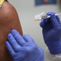 Lisa Taylor receives a COVID-19 vaccination from RN Jose Muniz as she takes part in a vaccine study at Research Centers of America, August 07, 2020 in Hollywood, Florida. Research Centers of America is currently conducting COVID-19 vaccine trials, impleme