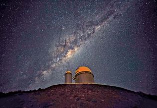 The 3.6-metre (142-inch) telescope at La Silla Observatory, part of the European Southern Observatory. The Milky Way Galaxy is seen in the sky.