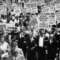 Martin Luther King, Jr. (center), with other civil rights supporters lock arms on as they lead the way along Constitution Avenue during the March on Washington, Washington, D.C., on August 28, 1963.