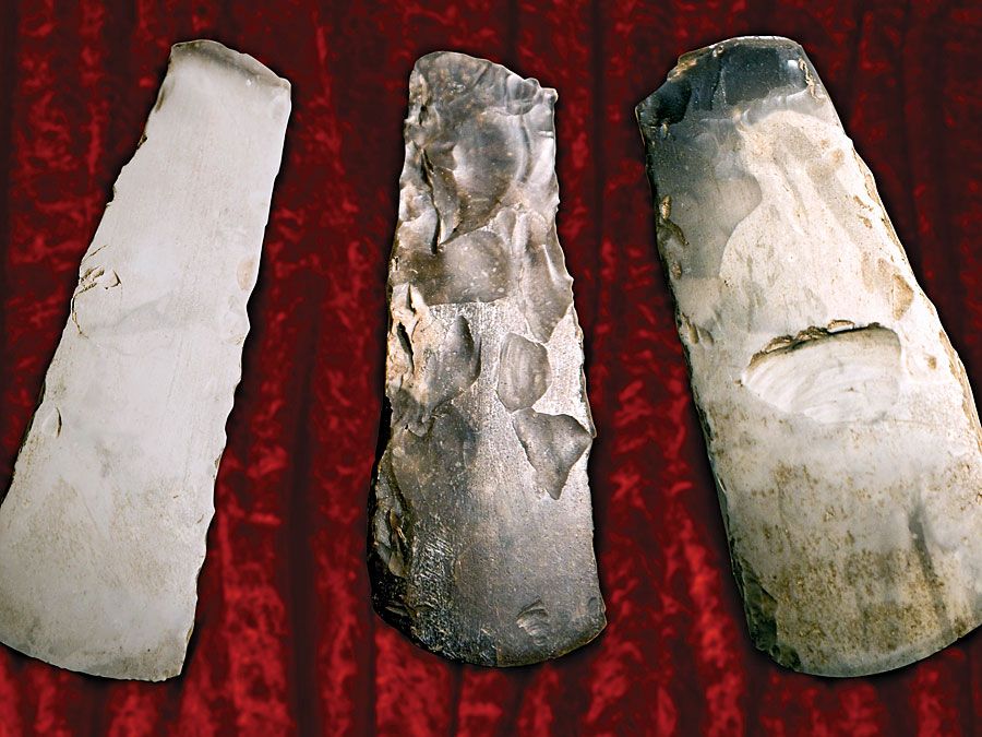 Three flint axes from the stone age. (prehistoric, tools, early humans, culture, archaeology, implements)