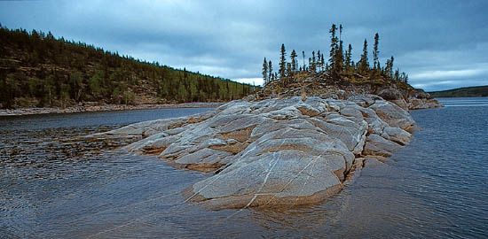 Precambrian bedrock of the Canadian Shield rising out of Reindeer Lake, on the border between northeastern Saskatchewan and northwestern Manitoba.