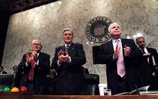 (From left to right) Senators Carl Levin, John Warner, and John McCain applauding U.S. service members who had recently returned from the Iraq War, Dec. 10, 2005.