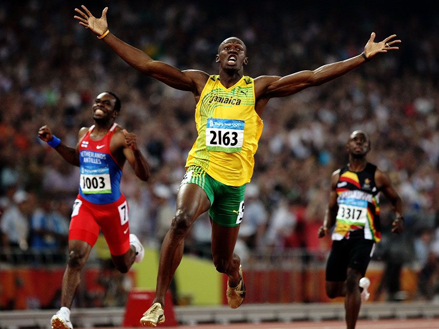 Usain Bolt of Jamaica reacts after breaking the world record with a time of 19.30 to win the gold medal as Churandy Martina (left) of Netherlands Antilles and Brian Dzingai of Zimbabwe come in after him in the Men&#39;s 200m Final at the National Stadium during Day 12 of the Beijing 2008 Olympic Games on August 20, 2008 in Beijing, China. (Summer Olympics, track and field, athletics)