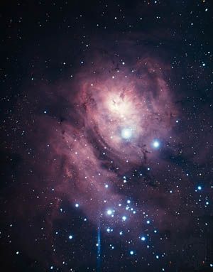 Lagoon Nebula (M8, NGC 6523) in the constellation Sagittarius.This bright diffuse nebula is so large that light from the stars involved does not penetrate its boundaries, and the bright nebula appears to be seen against a larger, darker one.