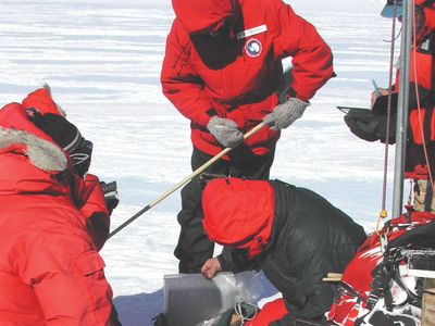 scientists recovering Antarctic meteorite