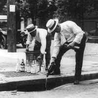 Prohibition - Whisky is poured down a sewer during Prohibition in the 1920s in the United States.