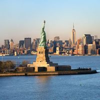 Statue of Liberty in front of the skyline of Manhattan, New York City, New York.