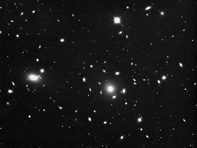 The Coma cluster, a spherically symmetrical group of galaxies with a high percentage of ellipticals.