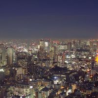 Aerial view of Tokyo, Japan at dusk circa 2009. Tokyo Tower (right) located in Shiba Park, Minato, Tokyo, Japan. Office buildings, architecture, skyscrapers, skyline.