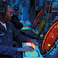 Air traffic controllers aboard the USS Essex monitoring radar screens, 2003.